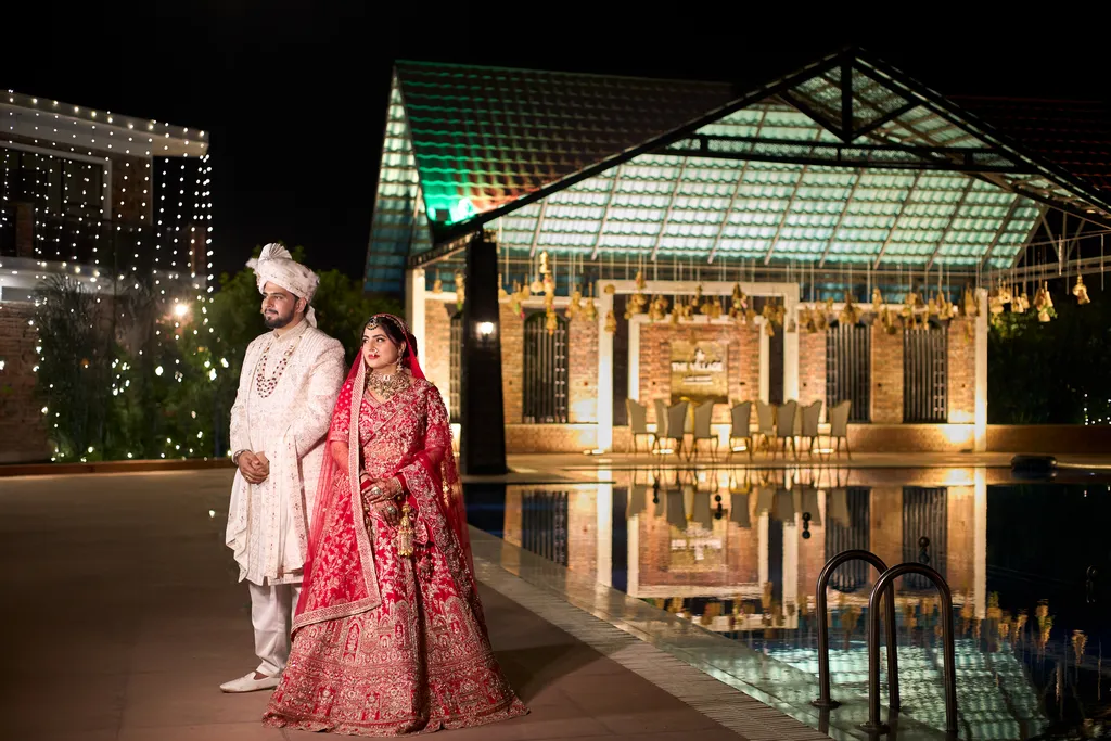 Wedding photography at The Village Lake Resort Varanasi - couple poolside night portrait by The WeddingShoot